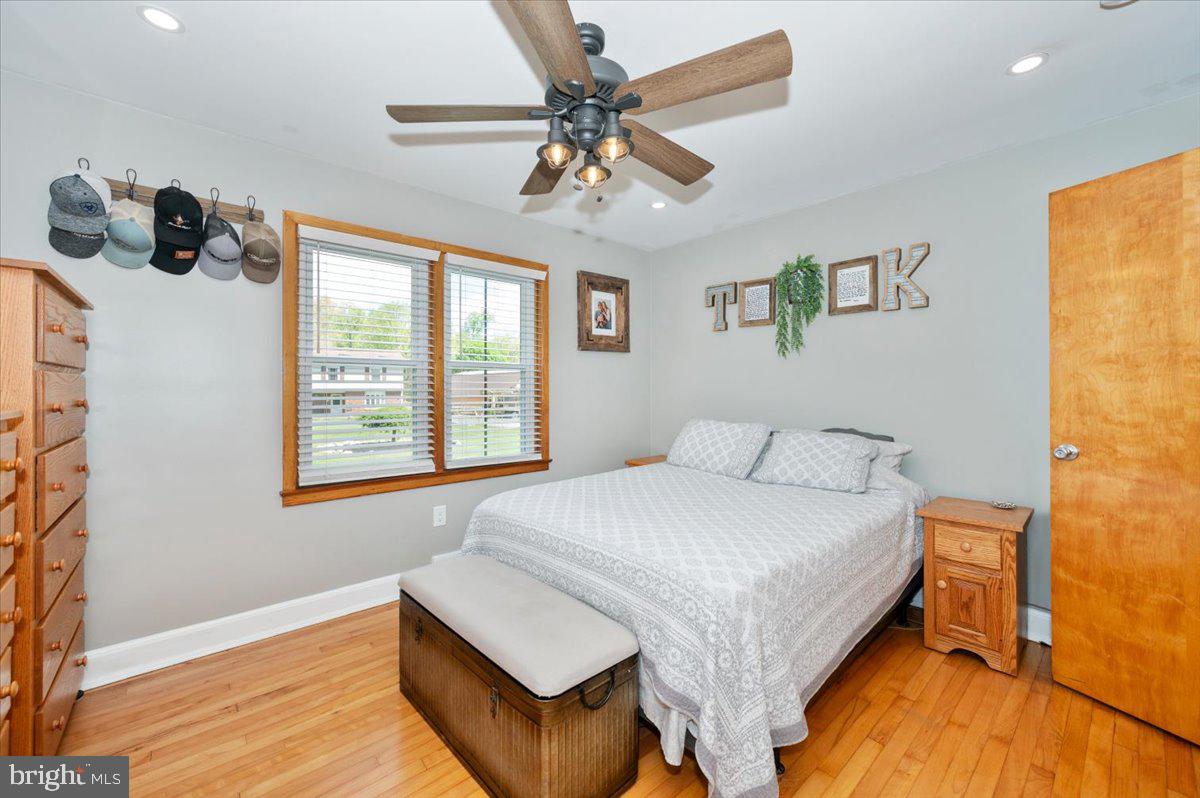 7117 Blue Mountain Road Thurmont, MD 21788 - Photo 21 of 80 a bedroom with a bed and a chandelier