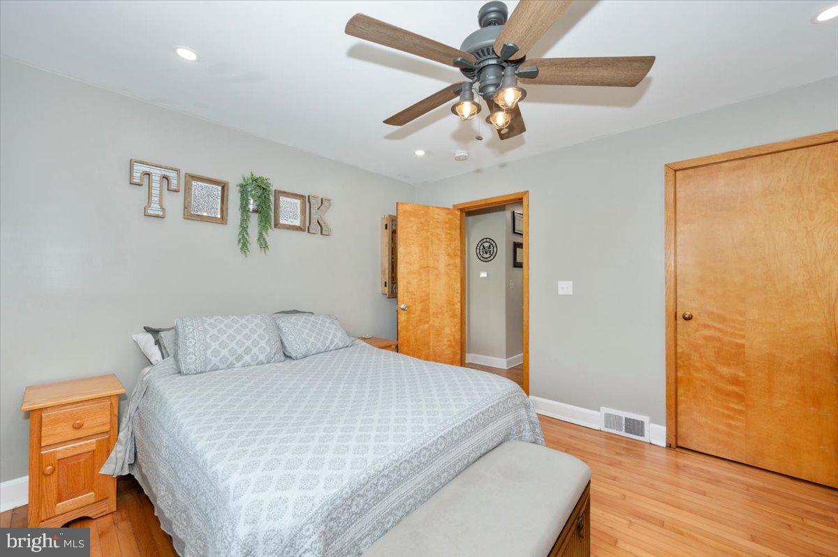 7117 Blue Mountain Road Thurmont, MD 21788 - Photo 22 of 80 a bedroom with a bed and a chandelier