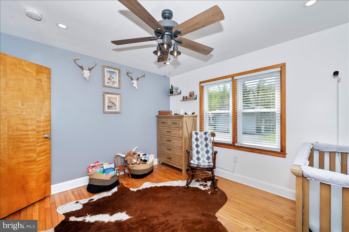 7117 Blue Mountain Road Thurmont, MD 21788 - Photo 24 of 80 a living room with furniture a chandelier and a window