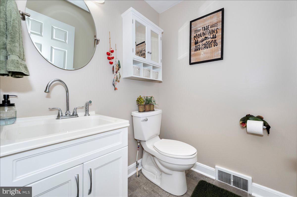 7117 Blue Mountain Road Thurmont, MD 21788 - Photo 32 of 80 a bathroom with a toilet a sink and mirror