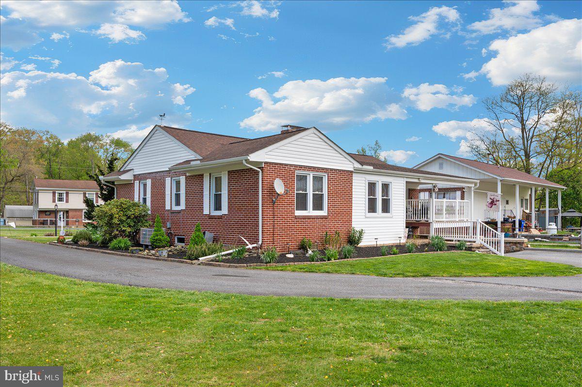 7117 Blue Mountain Road Thurmont, MD 21788 - Photo 41 of 80 a front view of a house with a garden and plants