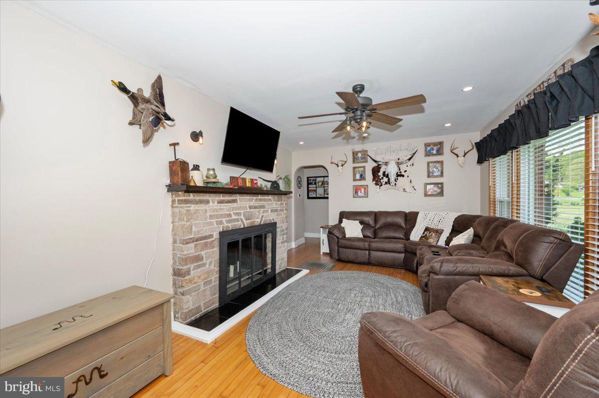 7117 Blue Mountain Road Thurmont, MD 21788 - Photo 10 of 80 a living room with furniture a fireplace and a flat screen tv