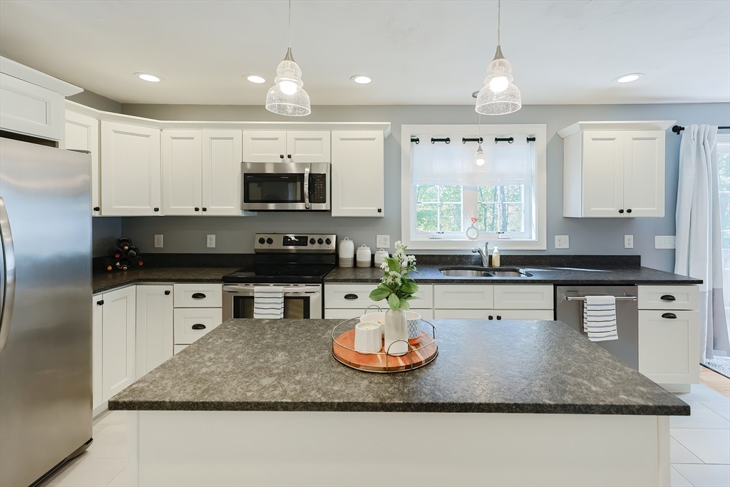 131 Pommogussett Road Rutland, MA 01543 - Photo 11 of 38 a kitchen with granite countertop a sink a counter top space appliances and cabinets