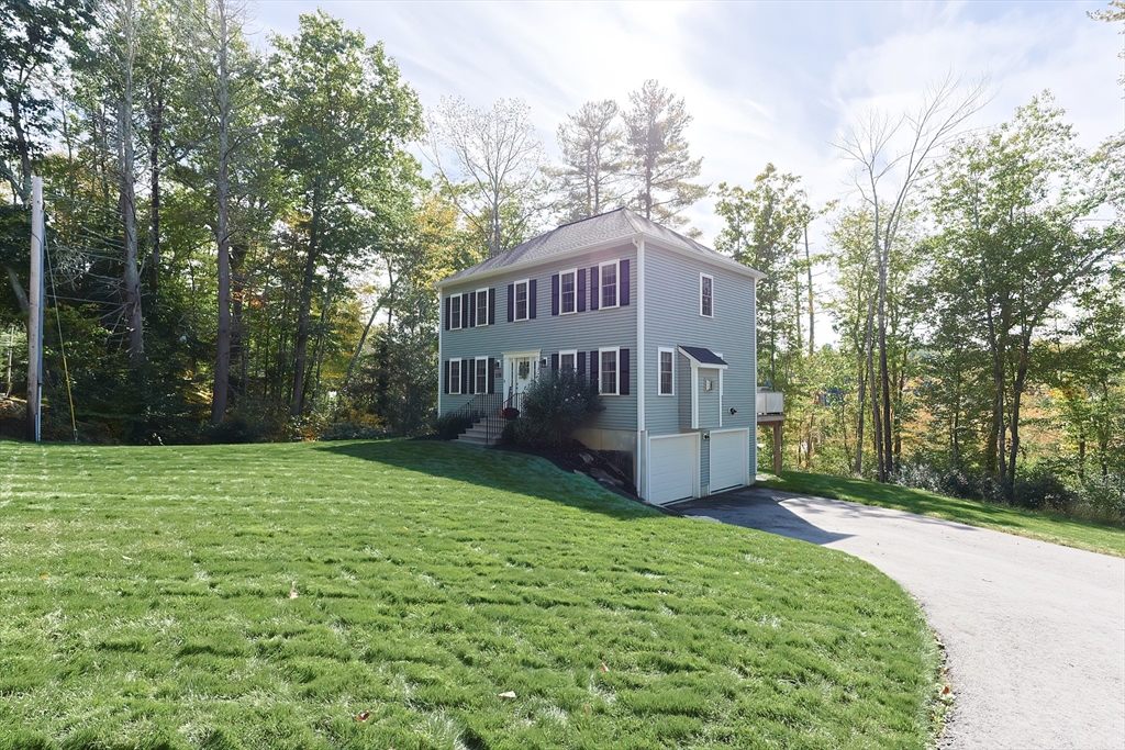 131 Pommogussett Road Rutland, MA 01543 - Photo 31 of 38 a view of a house with a yard and large trees