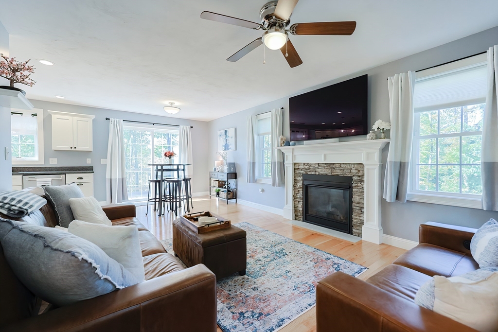 131 Pommogussett Road Rutland, MA 01543 - Photo 4 of 38 a living room with furniture a flat screen tv and a fireplace