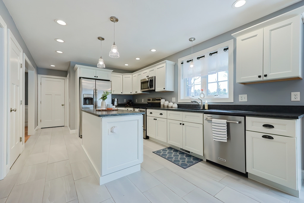 131 Pommogussett Road Rutland, MA 01543 - Photo 8 of 38 a kitchen with stainless steel appliances kitchen island granite countertop a refrigerator and a stove top oven