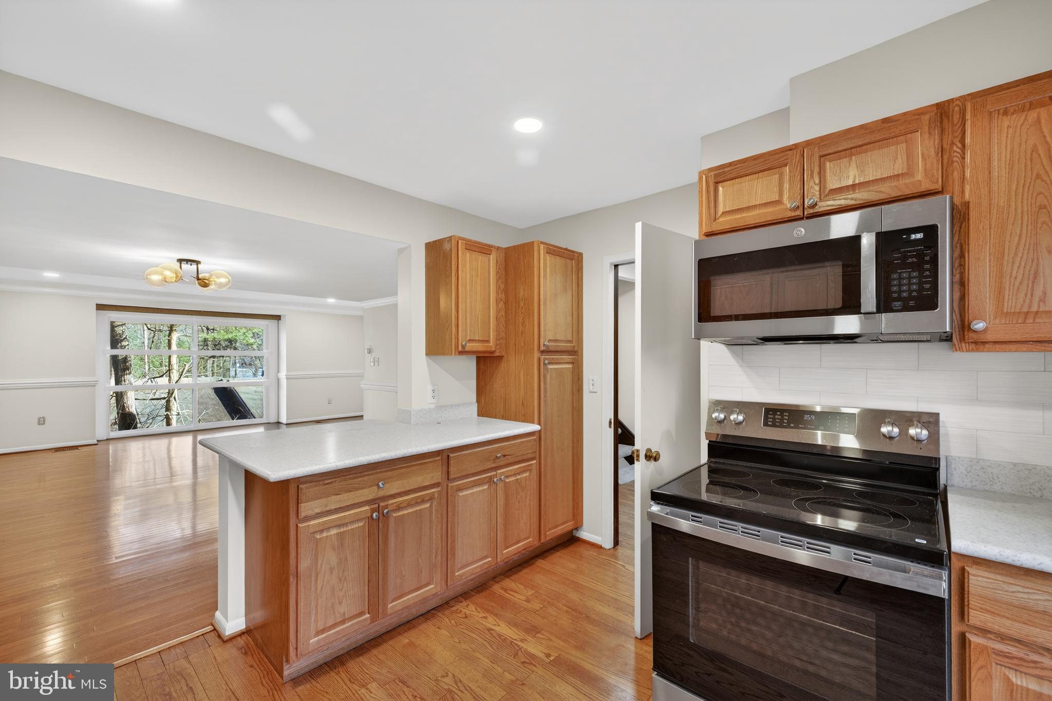 9250 Three Oaks Drive Silver Spring, MD 20901 - Photo 12 of 45 a kitchen with stainless steel appliances a stove sink microwave and refrigerator