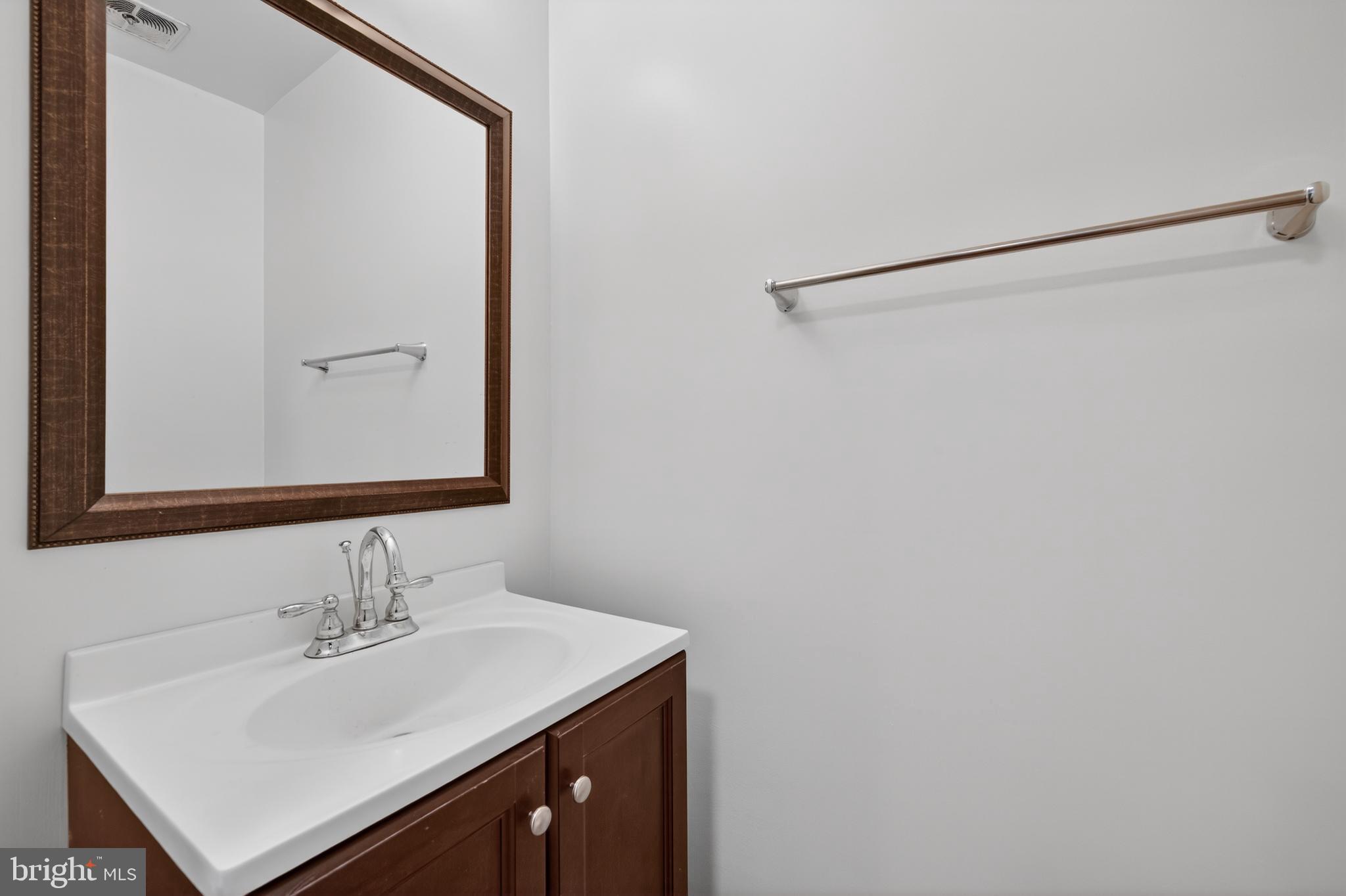 9250 Three Oaks Drive Silver Spring, MD 20901 - Photo 15 of 45 a bathroom with a sink and a mirror