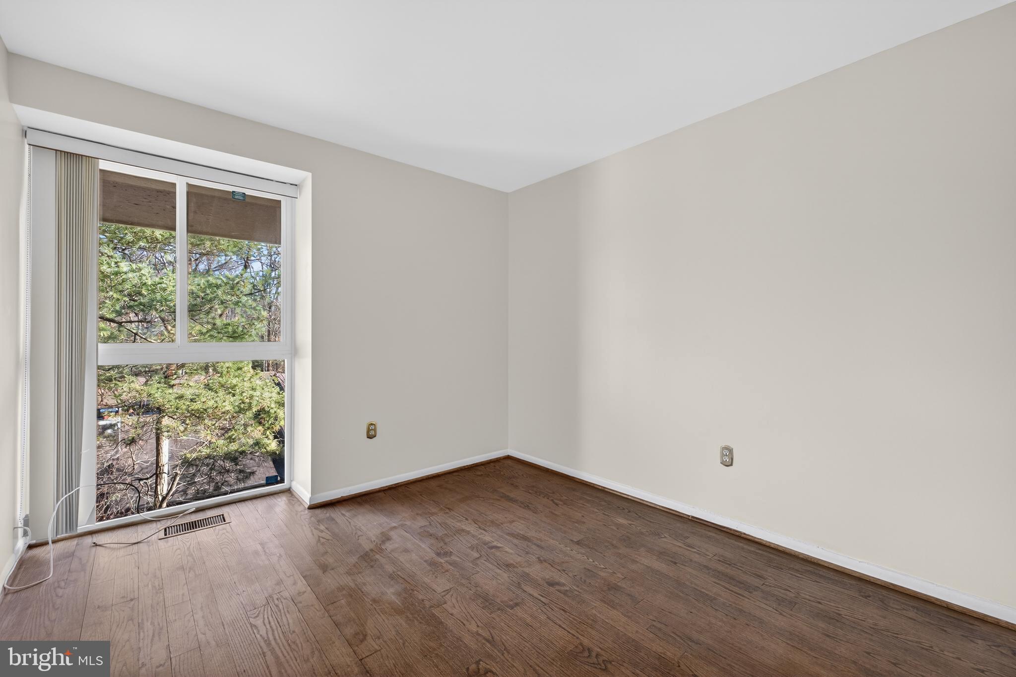 9250 Three Oaks Drive Silver Spring, MD 20901 - Photo 25 of 45 an empty room with wooden floor and windows