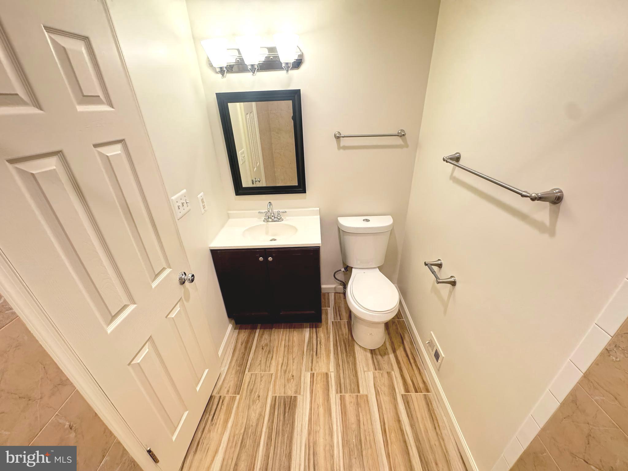 9250 Three Oaks Drive Silver Spring, MD 20901 - Photo 29 of 45 a bathroom with a sink and a mirror