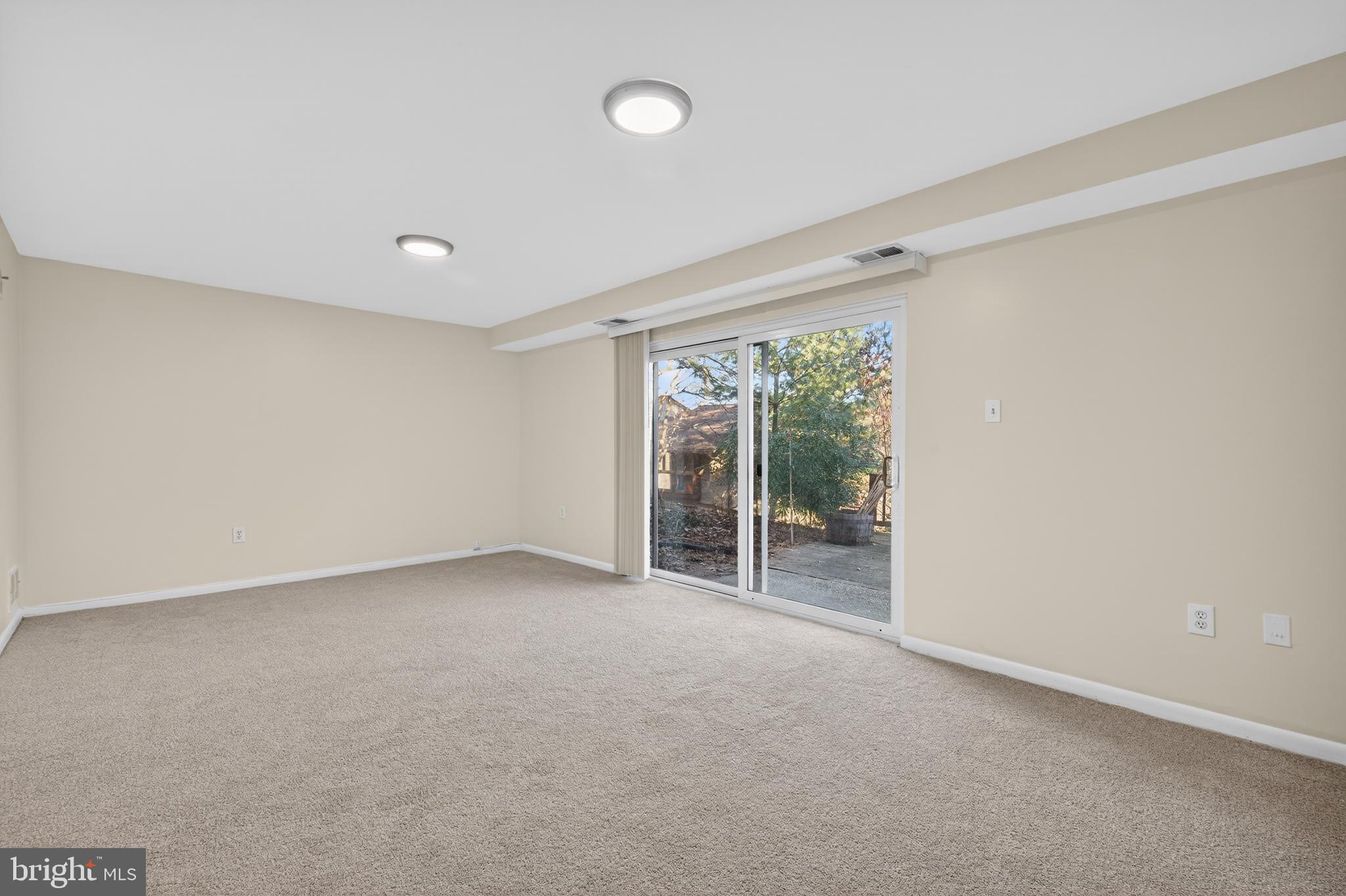 9250 Three Oaks Drive Silver Spring, MD 20901 - Photo 33 of 45 an empty room with floor to ceiling window and an outdoor view