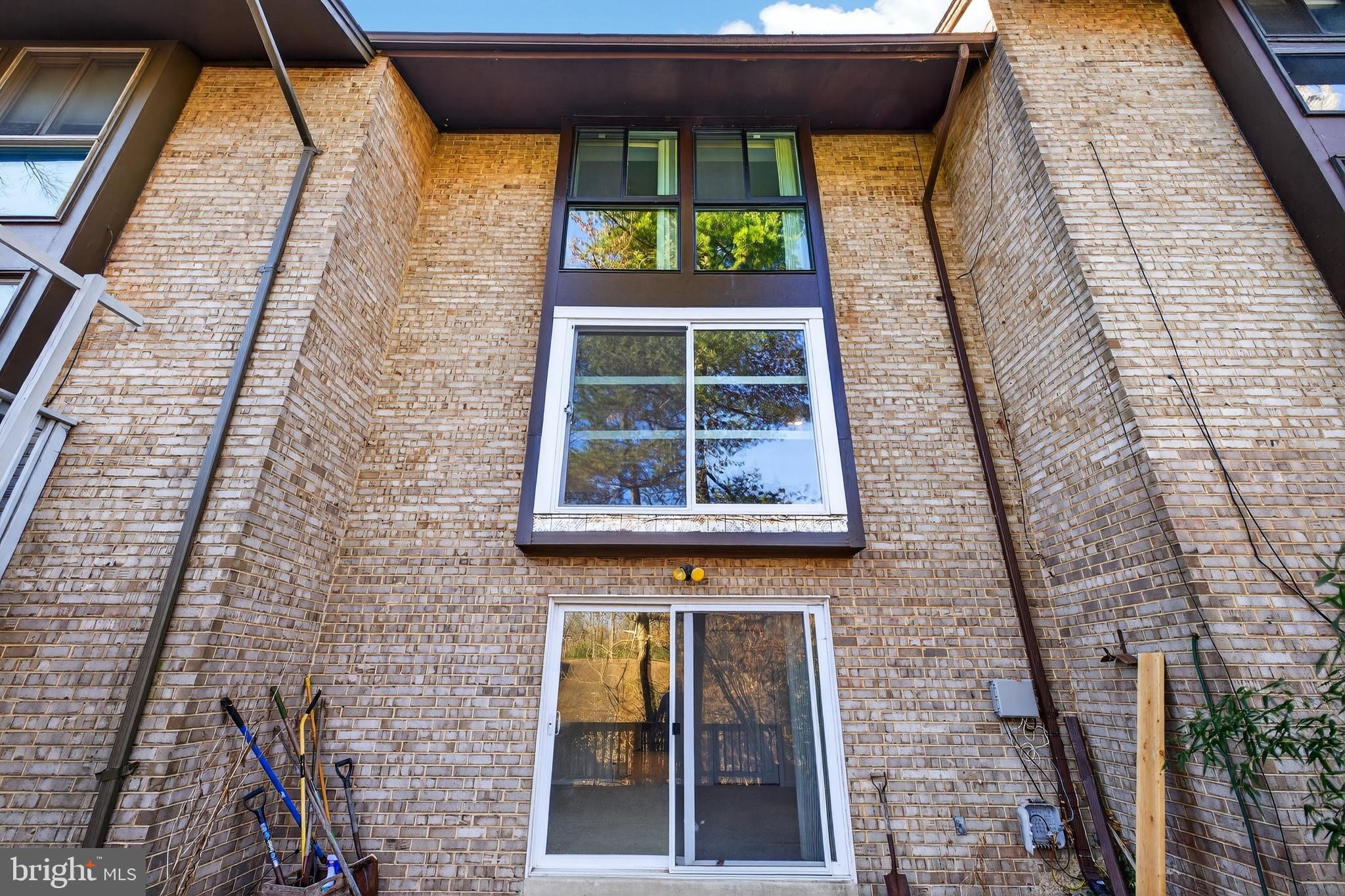 9250 Three Oaks Drive Silver Spring, MD 20901 - Photo 44 of 45 a view of a brick house with a large windows