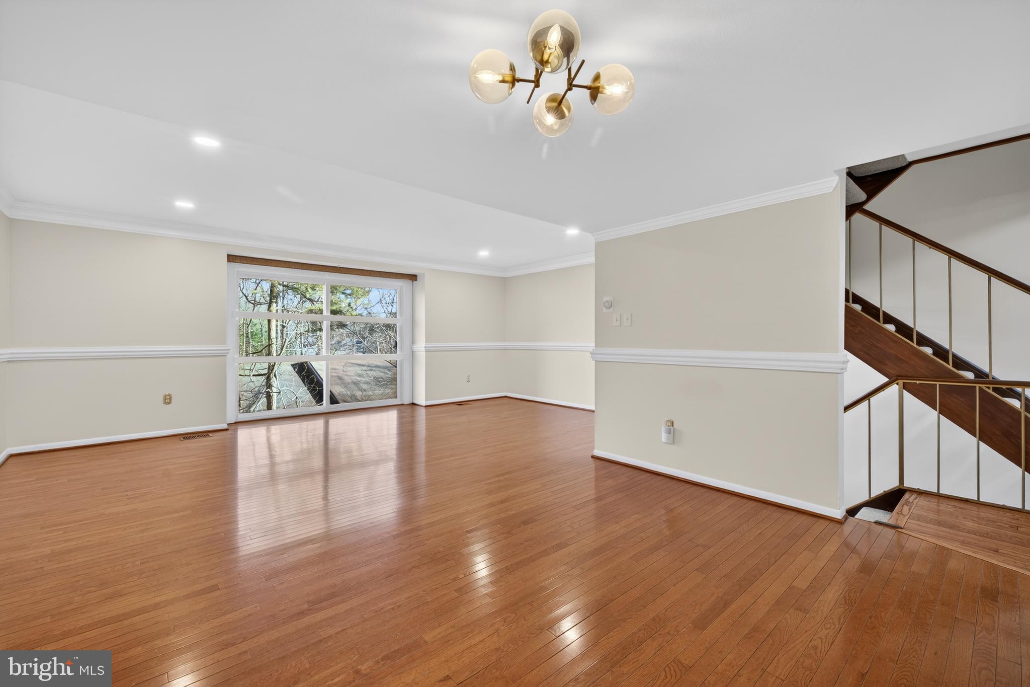 9250 Three Oaks Drive Silver Spring, MD 20901 - Photo 6 of 45 a view of an empty room with a window and wooden floor