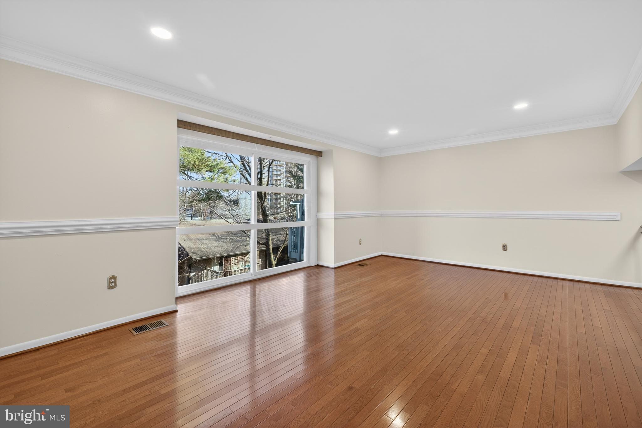 9250 Three Oaks Drive Silver Spring, MD 20901 - Photo 7 of 45 wooden floor in an empty room with a window