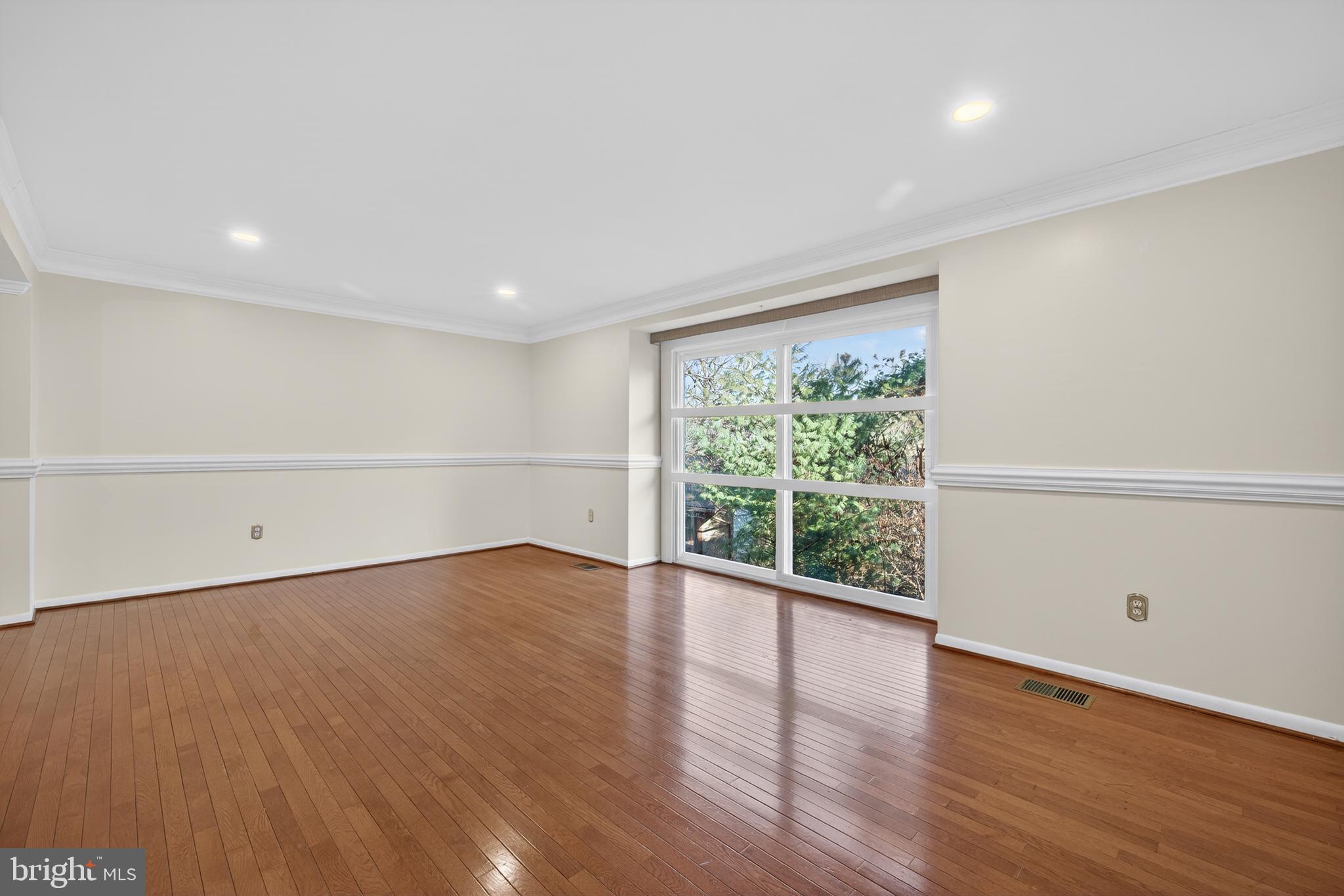 9250 Three Oaks Drive Silver Spring, MD 20901 - Photo 8 of 45 a view of an empty room with wooden floor and a window