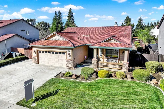 a front view of a house with swimming pool having outdoor seating
