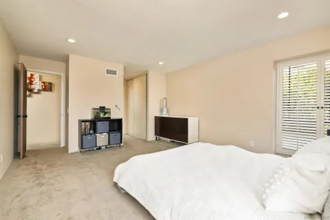 a bedroom with a bed and a table in it