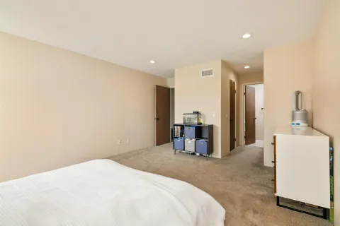 a bedroom with a bed and a large mirror