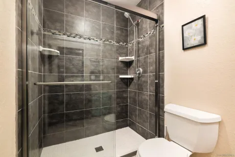 a bathroom with a toilet and a shower