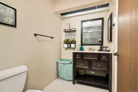 a bathroom with a sink a mirror and a toilet
