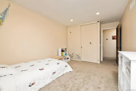 a bathroom with a toilet a sink a mirror a light fixture and vanity