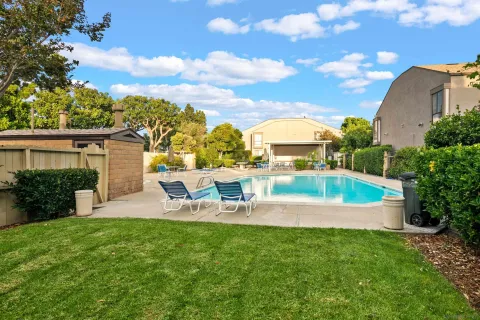 a view of backyard with seating area and barbeque oven