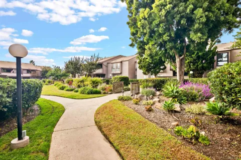 an aerial view of residential houses with outdoor space and parking