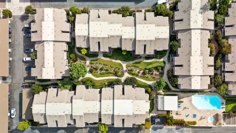 a view of balcony with chairs and potted plants