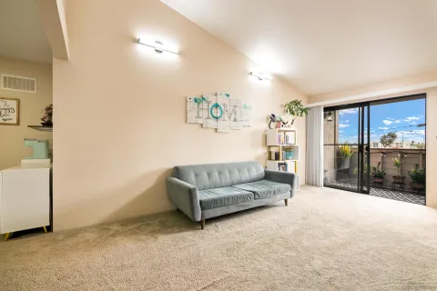 a living room with furniture a ceiling fan and a window