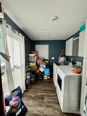 a bathroom with a sink a toilet a mirror and shower curtain
