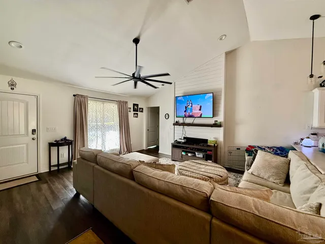 a living room with furniture and a flat screen tv