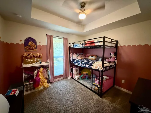 a room with lots of furniture and a baby crib