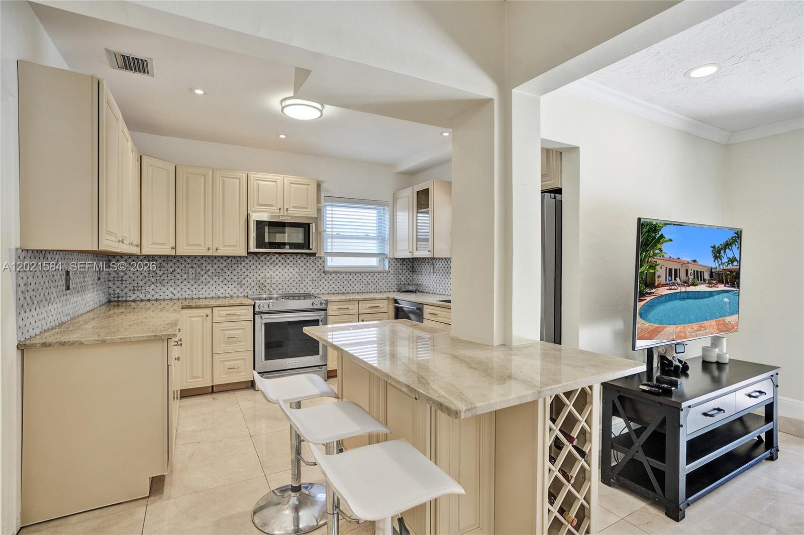 811 Northeast 73rd Street Miami, FL 33138 - Photo 13 of 51 a kitchen with a stove a sink and a refrigerator