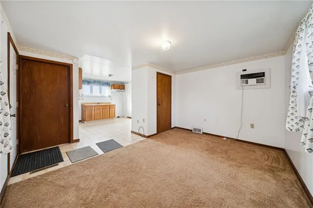 a view of a kitchen with refrigerator and windows