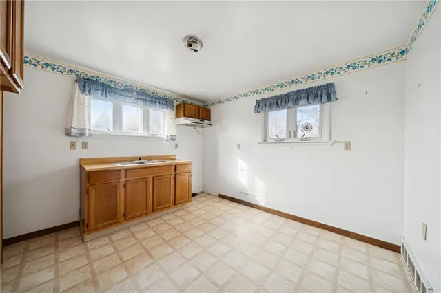a kitchen with a stove top oven and cabinets