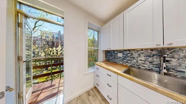 a kitchen with a refrigerator and window