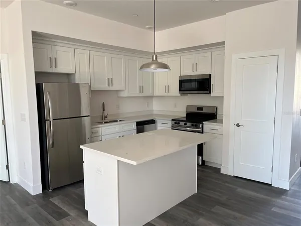 a kitchen with stainless steel appliances a refrigerator sink and cabinets