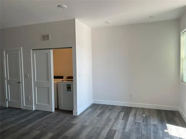 a view of a refrigerator in kitchen and wooden floor