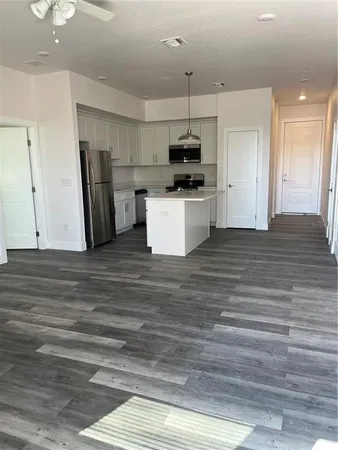 a kitchen with stainless steel appliances kitchen island wooden cabinets and granite counter tops
