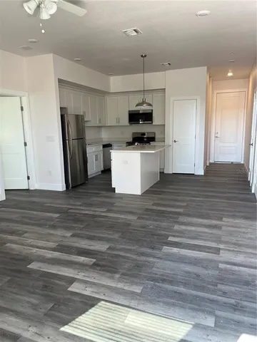a kitchen with stainless steel appliances kitchen island wooden cabinets and granite counter tops