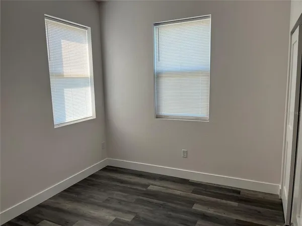 a bathroom with a granite countertop toilet sink and mirror