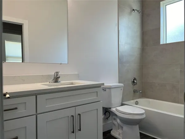 a room with wooden floor and windows