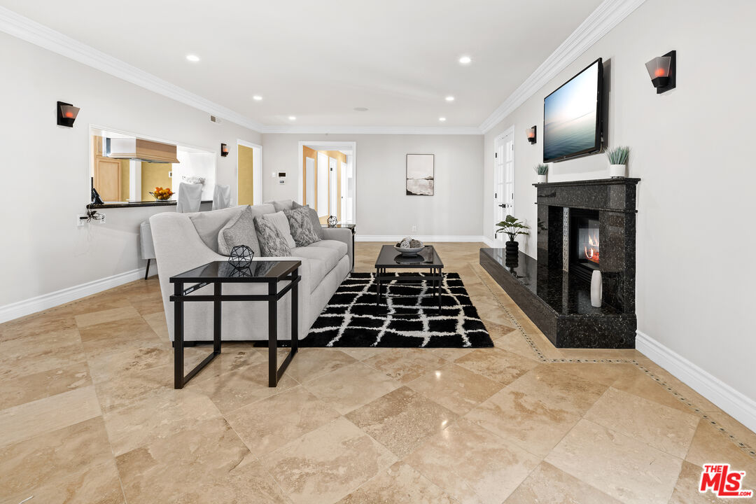 2563 Hutton Drive Beverly Hills, CA 90210 - Photo 1 of 69 a living room with furniture a flat screen tv and a fireplace