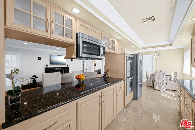 a kitchen with stainless steel appliances a sink a stove and a refrigerator