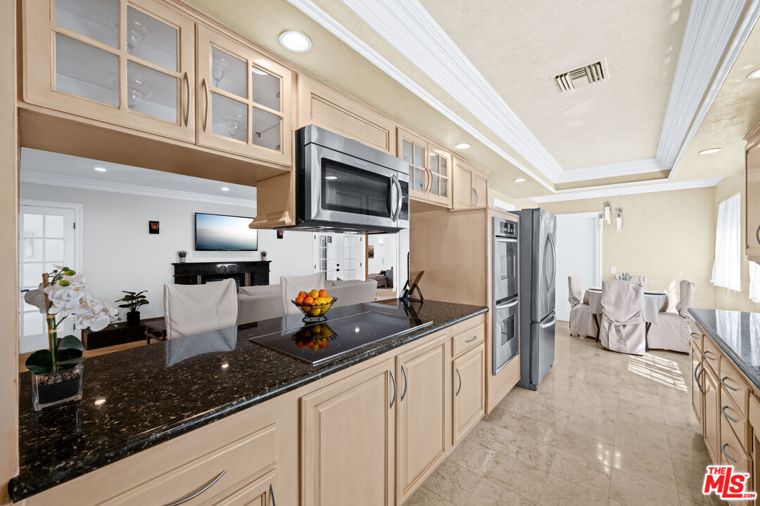 2563 Hutton Drive Beverly Hills, CA 90210 - Photo 12 of 69 a kitchen with stainless steel appliances a sink a stove and a refrigerator