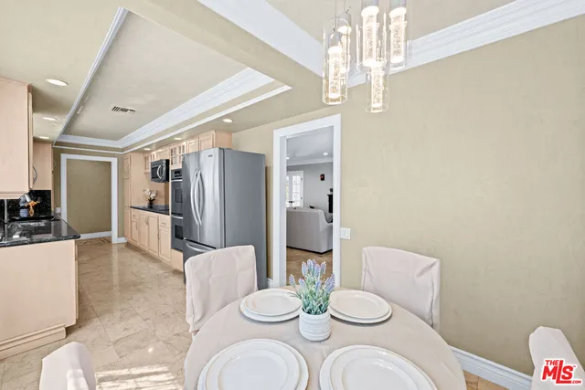a dining room with furniture and a chandelier