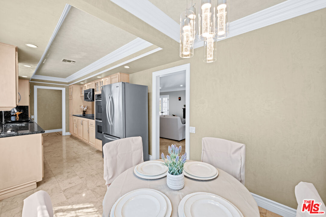 2563 Hutton Drive Beverly Hills, CA 90210 - Photo 14 of 69 a dining room with furniture and a chandelier