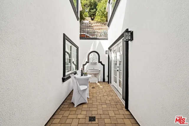 a living room with furniture a window and a potted plant