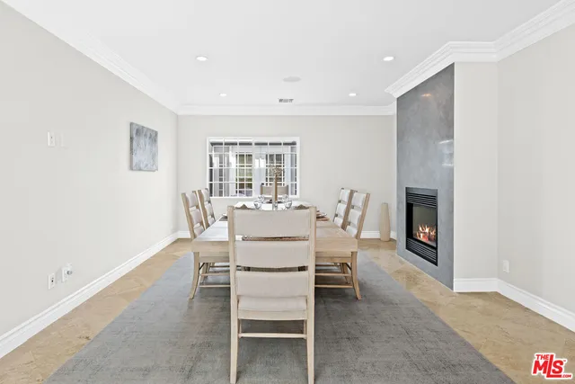 a living room with a couch a fireplace and a potted plant
