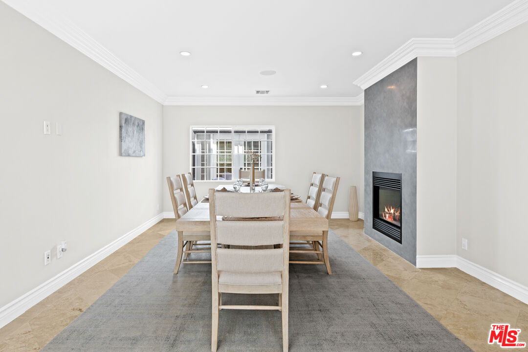 2563 Hutton Drive Beverly Hills, CA 90210 - Photo 18 of 69 a dining room with furniture and a fireplace
